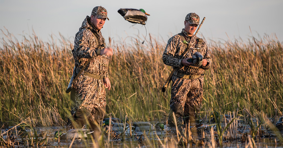 Waterfowl hunters setting up decoys. Photo by Mossy Oak