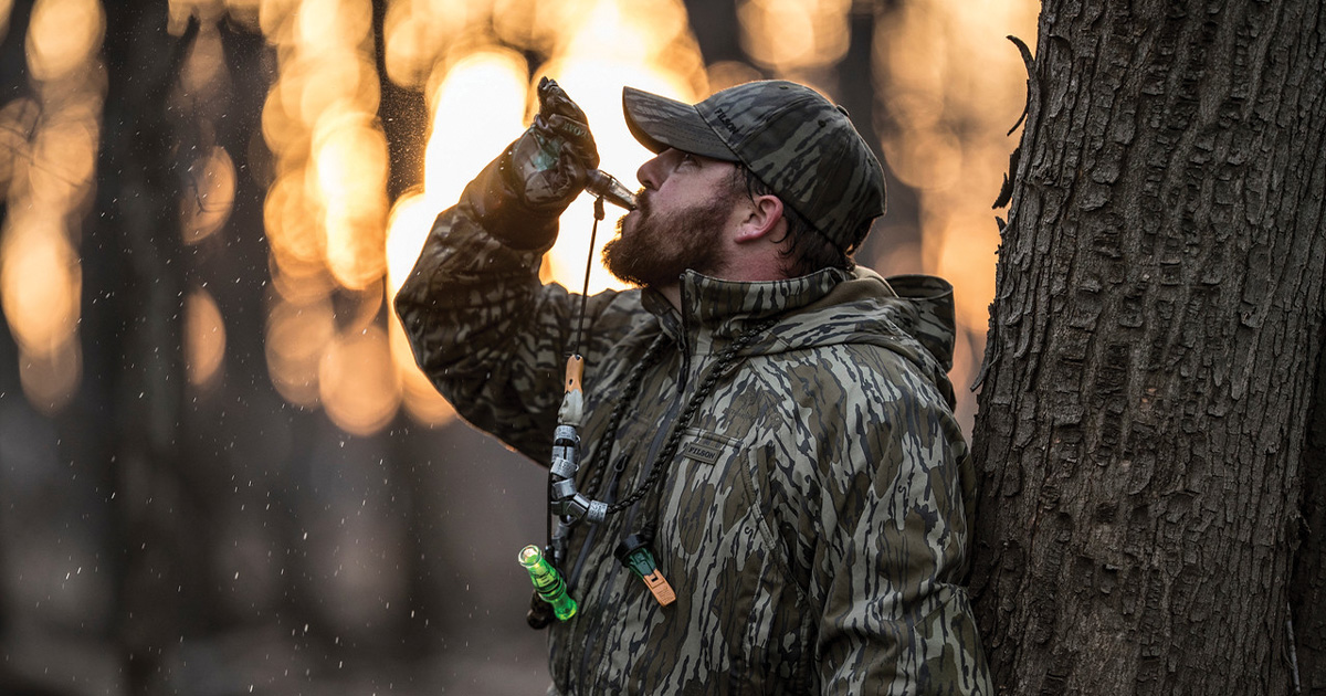 Duck hunter blowing a duck call on a duck hunt. Photo by Mossy Oak.jpg