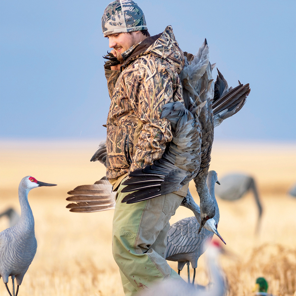 Hunter with harvested sandhill crane. Photo by Steve Oehlenschlager